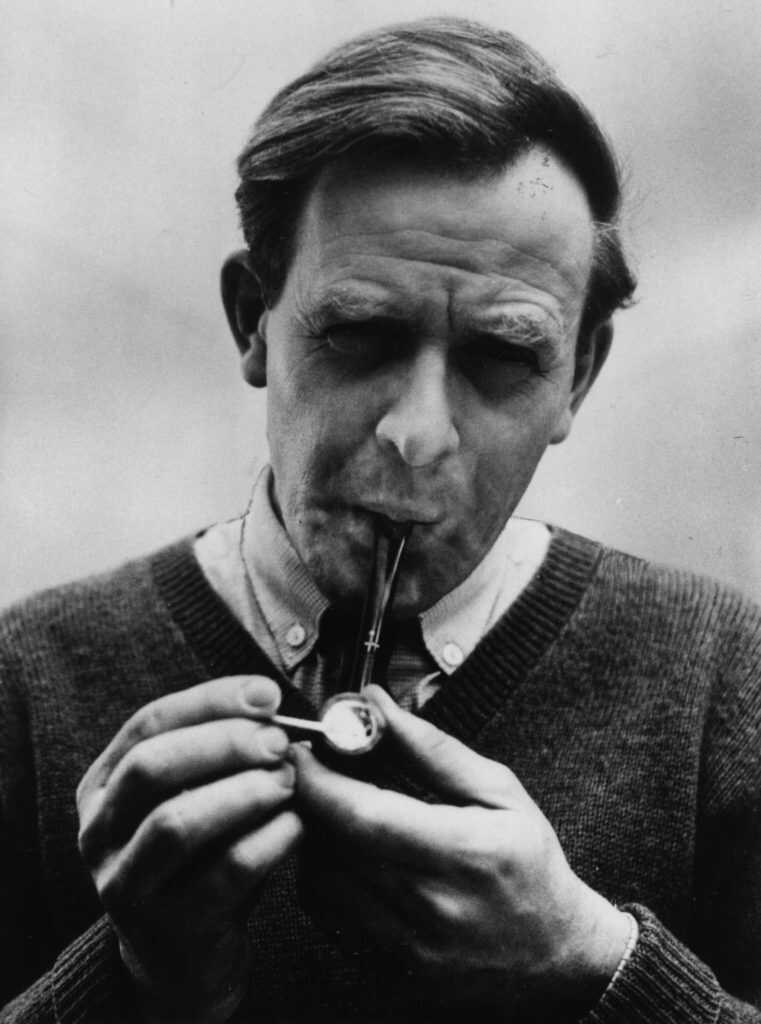 1980: John Le Carre, (pseudonym of David John Moore Cornwell) (1931 - ) the English novelist, lighting his pipe. (Photo by Evening Standard/Getty Images)